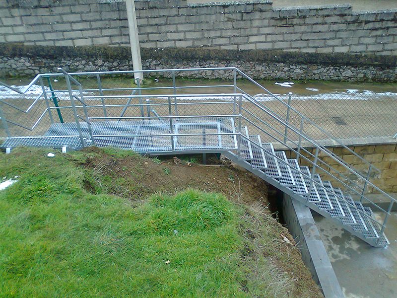 Escalera de exterior con estructura y barandilla metálica.